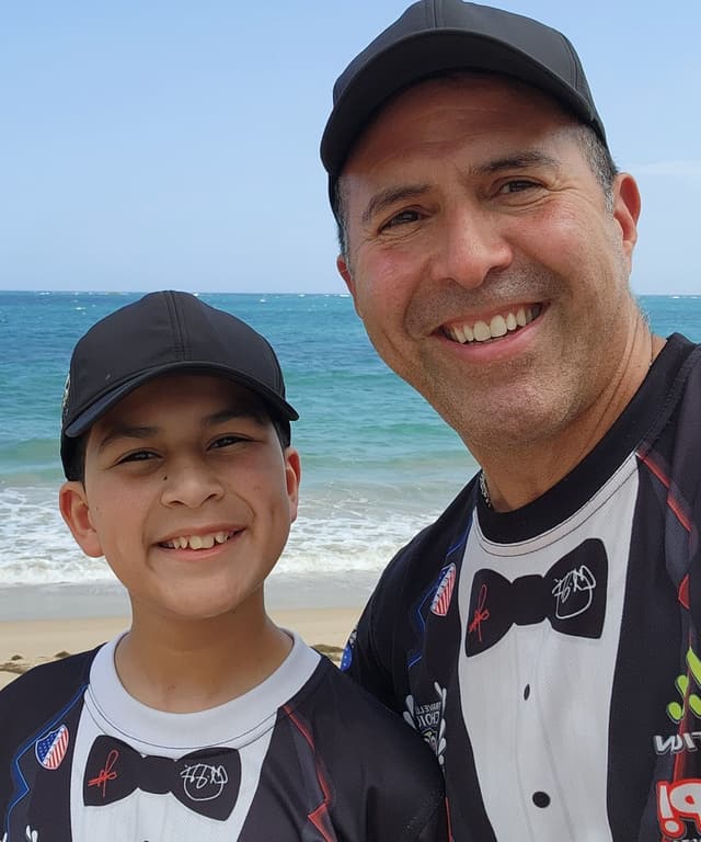 Carlos Alexis and his son on a Puerto Rico beach