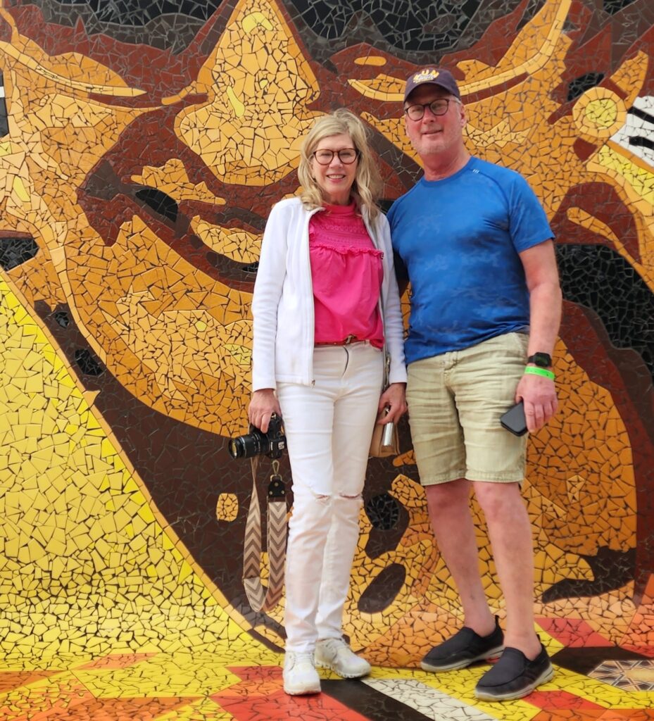 Senior couple traveling to Puerto Rico experiencing Bucketlist Tours' Old San Juan Ageless Elegance, Heritage, and Spirits private tour, comfortably discovering San Juan's vibrant urban art scene in a relaxed and enriching way.