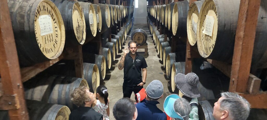 Family traveling to Puerto Rico with seniors and kids experiencing Bucketlist Tours' Old San Juan Ageless Elegance, Heritage, and Spirits private tour, doing the backstage historic tour at World's Finest Rum Distillery: Ron del Barrilito.