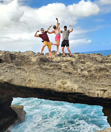 A group of friends strikes a fun pose atop a dramatic rock formation at Mar Chiquita, overlooking the crashing waves of Puerto Rico’s northern coast. This unique and exclusive trail is part of Bucketlist Tours’ Northern Coastal Adventure, blending exploration and adventure in a stunning natural setting.