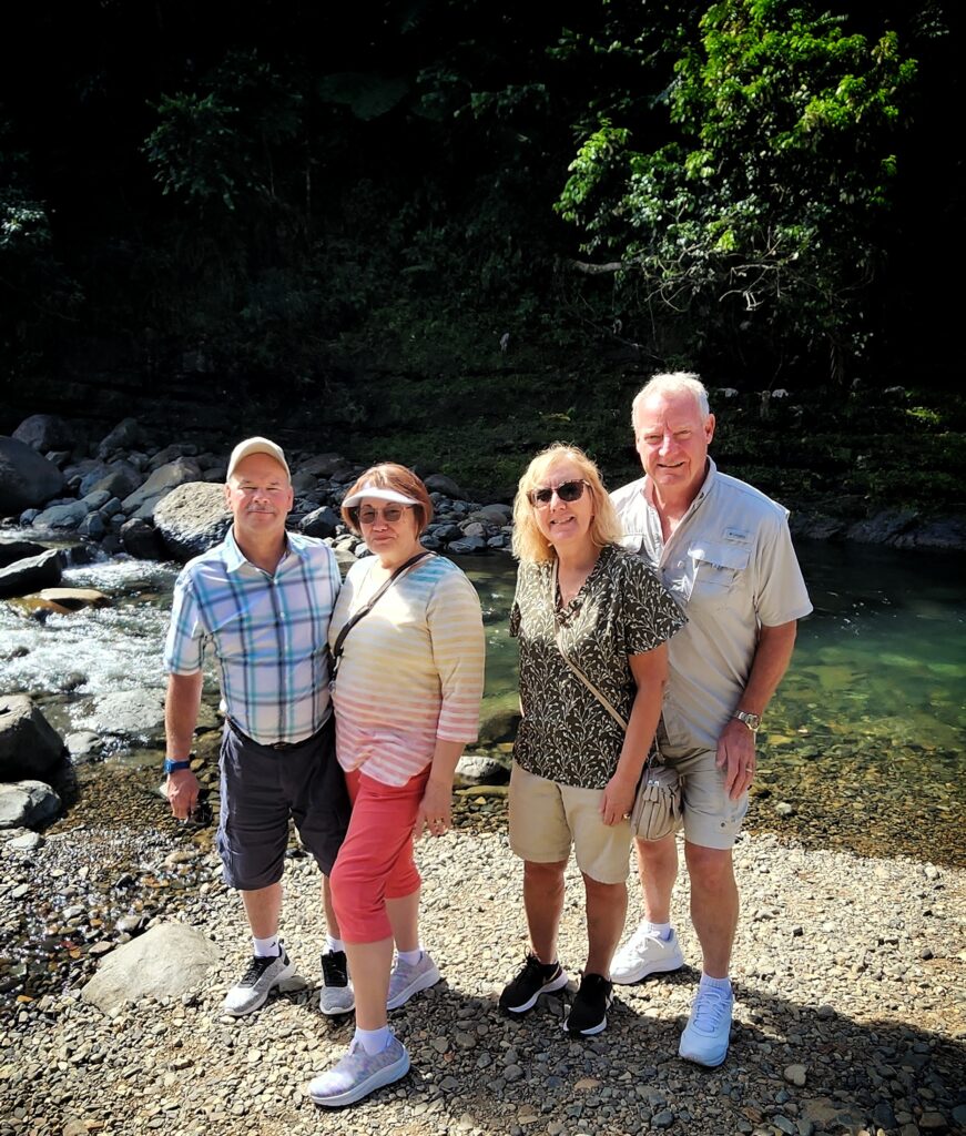 Two senior couples enjoying a scenic and leisurely walk by the creek at El Yunque’s Puente Roto on a sunny day. This tranquil stop is just before reaching Angelito Trail and is one of the highlights of Bucketlist Tours’ Colonial Wonders and Serene Rainforest private Old San Juan tour.