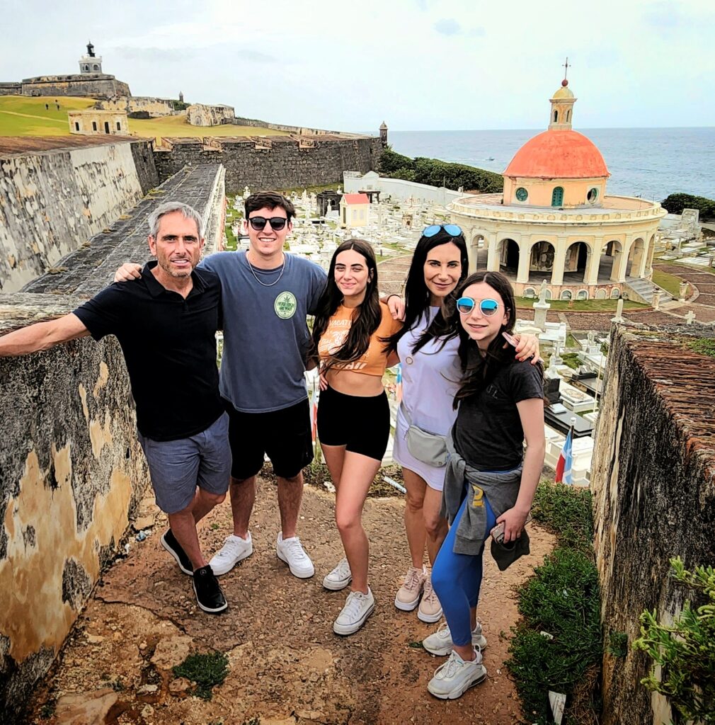 A family with kids and teenagers enjoying a private guided tour of Old San Juan’s historic sites, including the iconic El Morro fort, the ancient city walls, and the serene Santa María Magdalena de Pazzis Cemetery, with its breathtaking ocean views. These are just a few of the highlights of Bucketlist Tours’ Colonial Wonders and Serene Rainforest private Old San Juan tour.