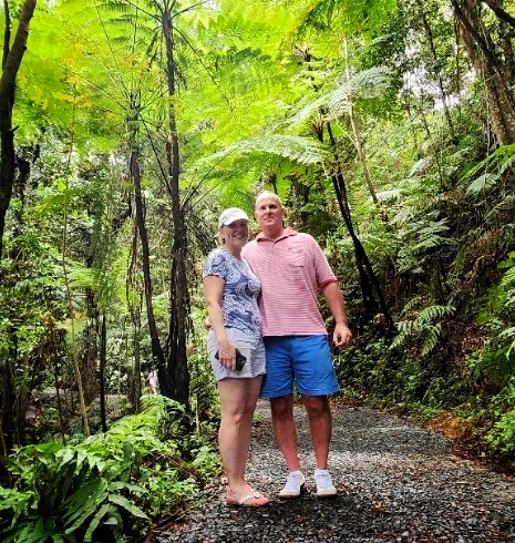 A senior couple stands together on the serene Angelito Trail in El Yunque Rainforest, surrounded by lush greenery and vibrant ferns. This easy and comfortable hike is part of Bucketlist Tours’ Colonial Wonders and Serene Rainforest private Old San Juan tour, offering a perfect blend of relaxation and exploration in Puerto Rico’s natural beauty.