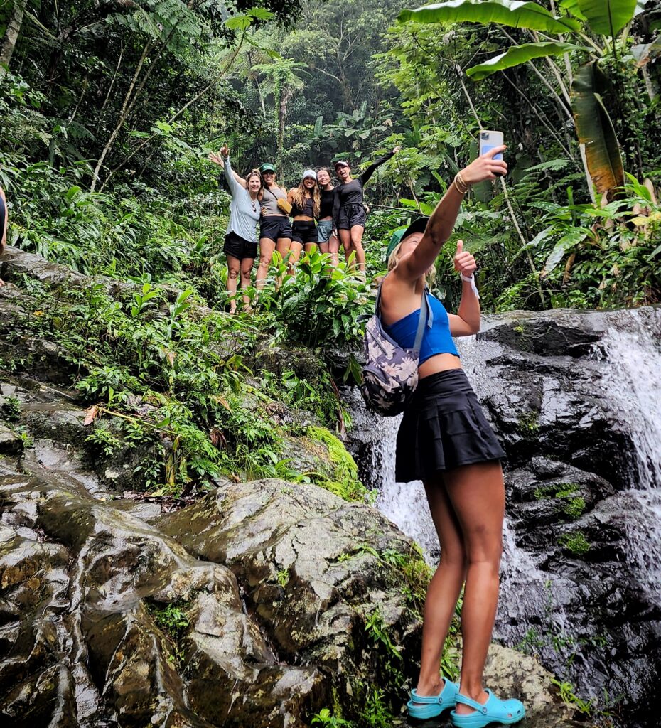 A lively bachelorette group stops to capture a cheerful selfie moment on their way to the second waterfall at Toro Negro’s Las Delicias. Surrounded by lush greenery and the sounds of cascading water, they are preparing to enjoy the cool, refreshing waters while basking in the privacy and exclusivity of Bucketlist Tours' Ocean Edge to Jungle’s Heart private tour, a tailored experience departing from San Juan, Dorado, and Rio Grande.