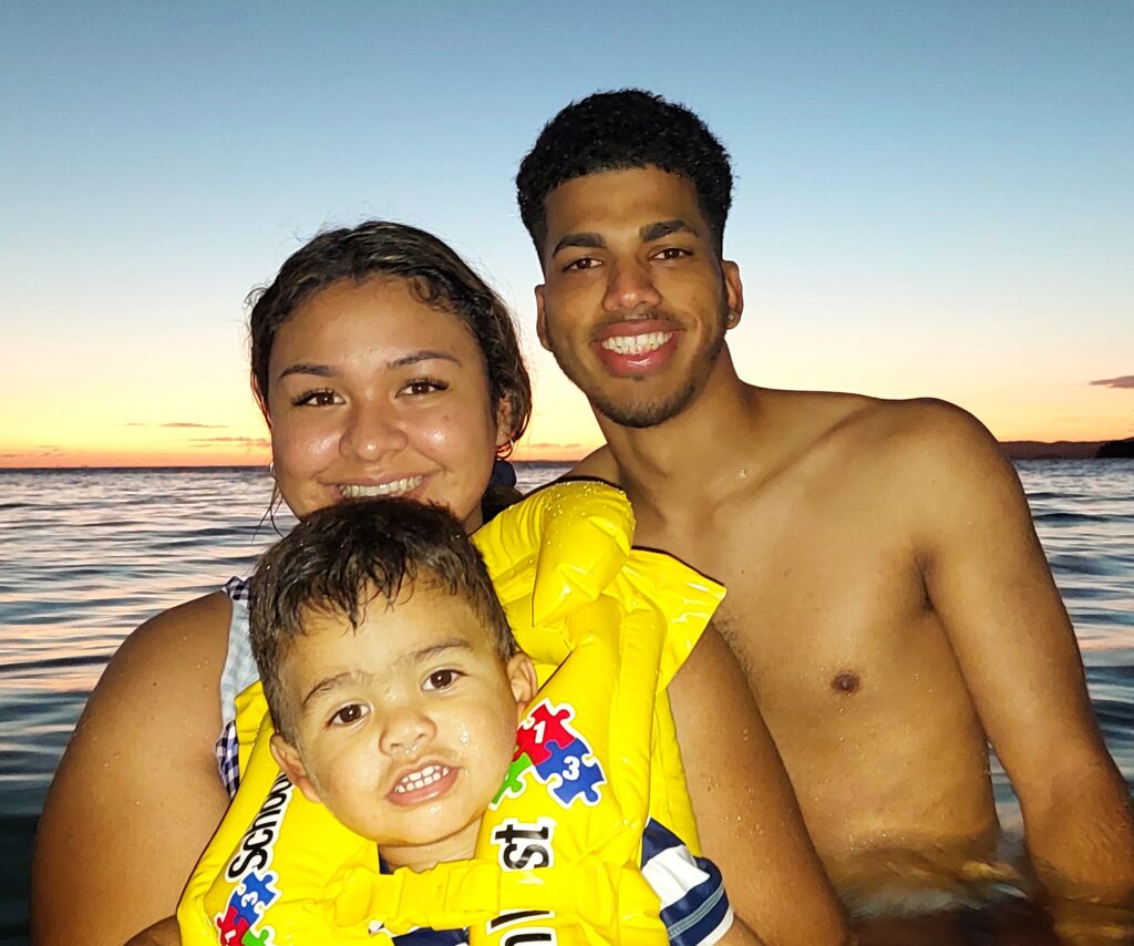 A young Latino couple with their toddler, visiting from Fernandina Beach and staying at the Condado Vanderbilt, enjoy a breathtaking Caribbean sunset as a prelude to their unforgettable private guided bioluminescent swim. This magical experience, part of Bucketlist Tours' Mystic Waters under the Sun & Stars and Discover Puerto Rico 3-Day Package Private Experiences, creates cherished family memories in the warm, glowing waters of La Parguera.