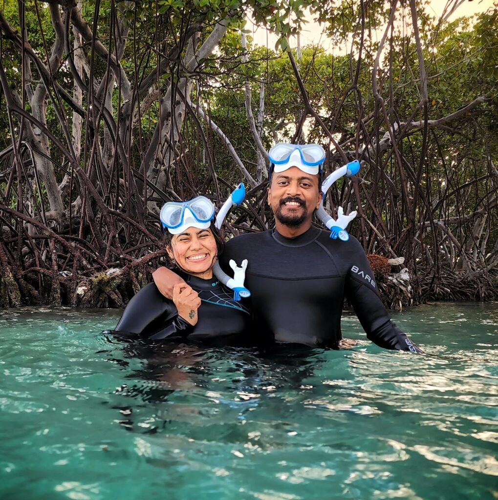 A smiling couple poses in the crystal-clear waters of La Parguera Cays after a snorkeling adventure during the Mystic Waters under the Sun and Stars Private Experience. This moment was captured during the Mystic Waters Under the Sun & Stars experience as part of their personalized Discover Puerto Rico 3-Day Package, meticulously planned using Bucketlist Tours' custom travel form. The experience ensured seamless coordination and catered to their unique preferences, creating an unforgettable journey through Puerto Rico's natural wonders.