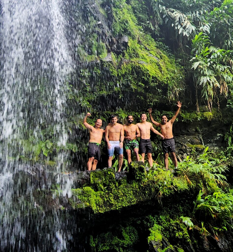 A bachelor group traveling to Puerto Rico and staying in the Ritz Carlton Reserve at Dorado Beach poses by the majestic Las Delicias waterfall, enveloped by the lush greenery of Toro Negro Rainforest in Puerto Rico. This thrilling moment is part of Bucketlist Tours’ Tropical Rainforest Magic & Wonders and the exclusive Discover Puerto Rico 3-Day Package Private Experiences.