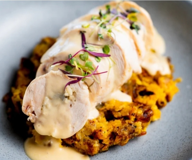 A beautifully plated dish of stuffed chicken breast over mamposteao rice, a specialty of Brújula Restaurant in La Parguera. This exquisite meal awaits you after a magical swim in the glowing waters of La Parguera’s bioluminescent bay. As part of the Bucketlist Tours Mystic Waters under the Sun & Stars and Discover Puerto Rico 3-Day Package Private Experiences, your guide pre-orders your selected meal à la carte, ensuring it’s ready upon your arrival. Guests can also change into dry clothes at the Parguera Plaza Hotel for a comfortable dining and travel experience back.