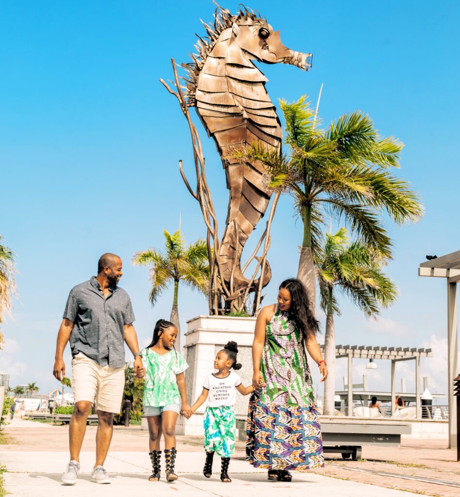 A family of four traveling to Puerto Rico on by *Celebrity Cruises* is captured by their guide and ambassador as they walk along the pier, framed by the iconic seahorse sculpture and swaying palm trees. This joyful moment follows their exploration of Old San Juan’s top 90 landmarks, uncovering its colonial history, hidden secrets, and Puerto Rico’s remarkable transformation after becoming a Commonwealth of the United States. This special memory was part of their 4-hour Old San Juan's Whispers of Time private tour, the most comprehensive and history-dense sightseeing and walking experience of historic *Old San Juan*. The tour covers the entire *San Juan Islet*, featuring over 90 landmarks, including the *Capitol Building*, the *Walkway of the Presidents* honoring U.S. presidents who have visited the island, the North Wall, and the charming main streets of the old city. Perfectly tailored for cruise ship passengers, *shoreline excursion* tour offers three customizable durations—2 hours for a comfortable sightseeing overview in a luxury air-conditioned vehicle, 3 hours for exploration with photo stops, and 4 hours for a fully immersive experience with extended stops. Thoughtfully designed for couples, families with children, seniors, and those seeking a low-effort yet enriching journey, this *Old San Juan tour* ensures unforgettable memories.