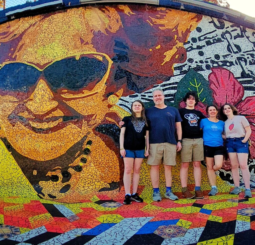 A family of 5, traveling to Puerto Rico and staying at the *Fairmont El San Juan*, is captured by their guide and ambassador as they pose in front of a vibrant mosaic mural commemorating *Felisa Rincón de Gautier*, the first-ever female mayor of a U.S. capital city. The couple learns about her remarkable contributions and how she embraced Puerto Rico’s transformation after becoming a Commonwealth of the United States. This moment is part of their Old San Juan's Whispers of Time private tour, the most comprehensive and history-rich tour of *Old San Juan*. The tour covers the entire San Juan Islet, featuring over 90 landmarks, including the *Capitol Building*, the *Walkway of the Presidents* honoring U.S. presidents who have visited the island, the North Wall, and the iconic main *cobblestone streets* of the old city. The tour is the perfect *shoreline excursion* for cruiseship passengers offering three customizable durations—2 hours for a sightseeing overview in a luxury air-conditioned vehicle, 3 hours for exploration with photo stops, and 4 hours for an immersive experience with extended stops—this *Old San Juan tour* is thoughtfully designed for couples, families with children, seniors, and those seeking a comfortable, low-effort, and enriching journey.