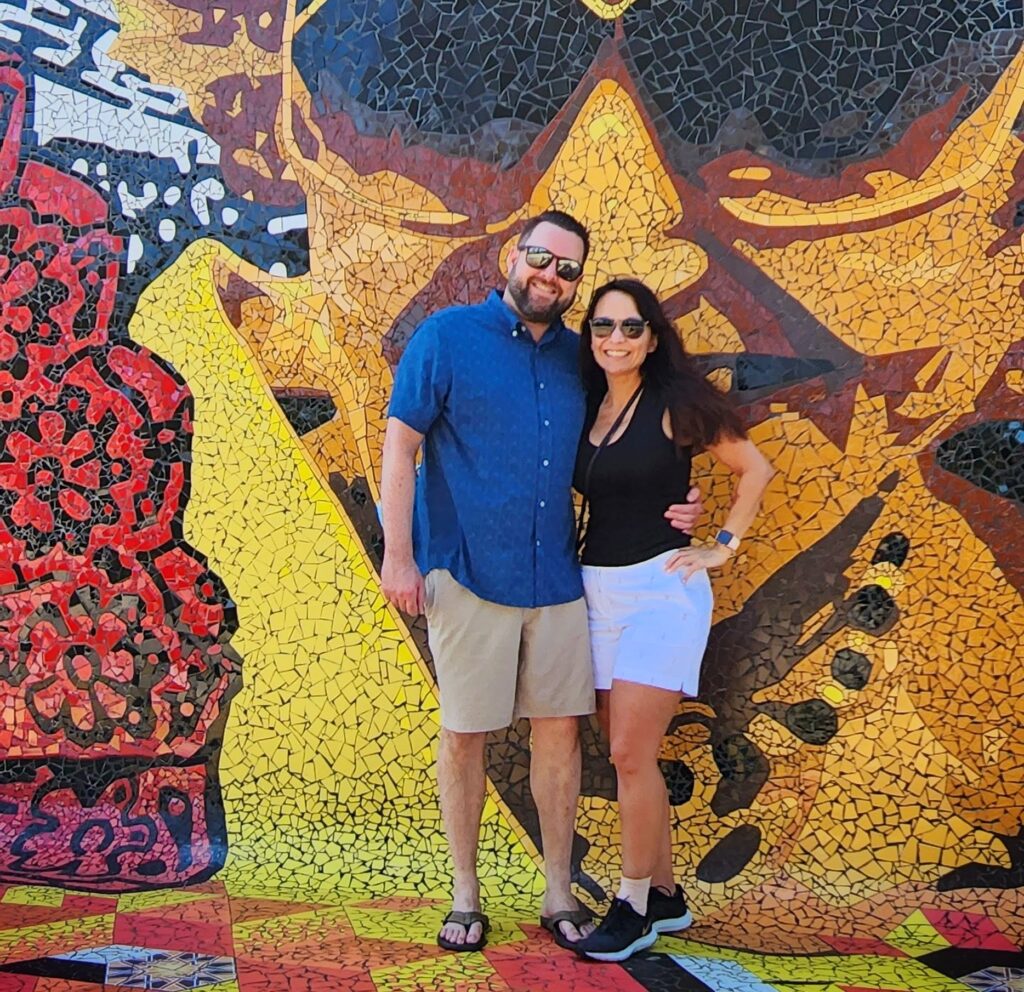 A couple traveling to Puerto Rico and staying at the luxurious *Ritz-Carlton Reserve* at *Dorado Beach* is captured by their guide and ambassador as they pose in front of a vibrant mosaic mural commemorating *Felisa Rincón de Gautier*, the first-ever female mayor of a U.S. capital city. This striking moment highlights their discovery of her inspiring leadership and Puerto Rico’s transformation after becoming a Commonwealth of the United States. This memorable experience is part of their Old San Juan's Whispers of Time private tour, the most comprehensive and history-rich exploration of *Old San Juan*. Spanning the entire San Juan Islet, the tour features over 90 landmarks, including the *Capitol Building*, the *Walkway of the Presidents* honoring U.S. presidents who have visited the island, the North Wall, and the iconic main streets of the old city. Available in three customizable durations—2 hours for a comfortable sightseeing overview in a luxury air-conditioned vehicle, 3 hours for exploration with photo stops, and 4 hours for an immersive experience with extended stops—this *Old San Juan tour* is thoughtfully curated for couples, families with children, seniors, and those seeking a comfortable, enriching journey.