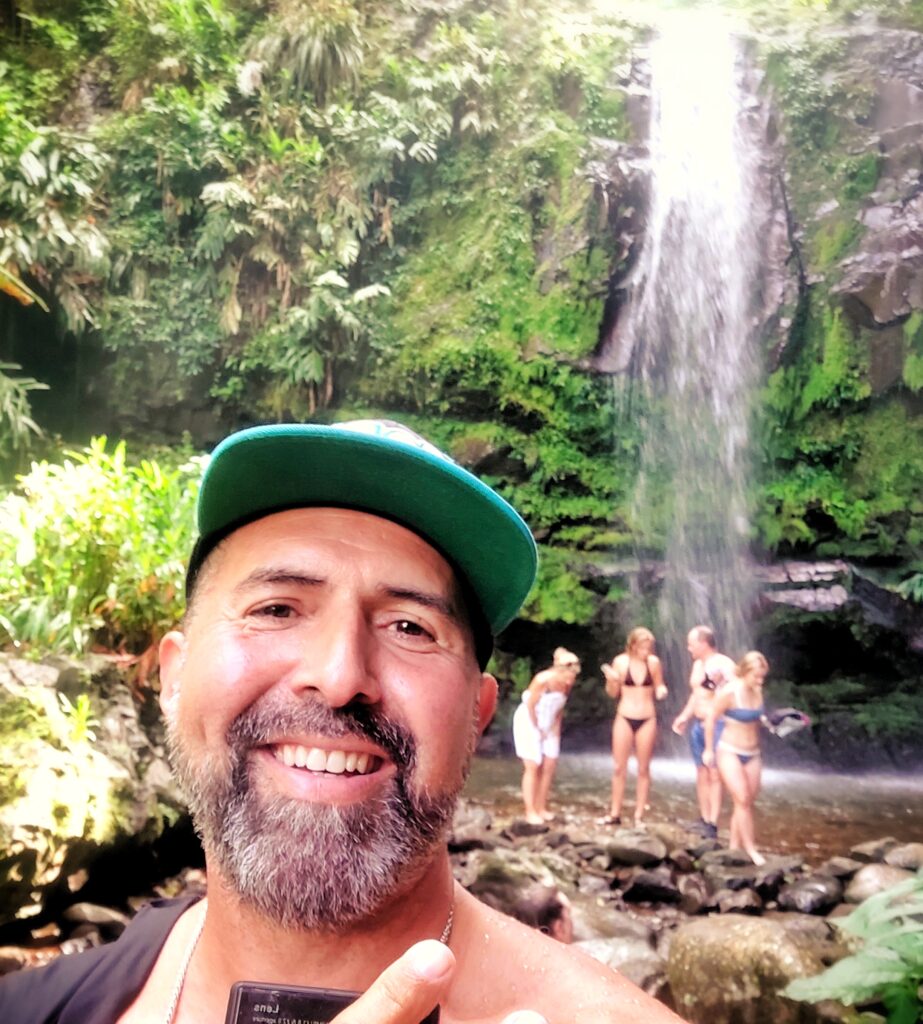 A selfie captured by Bucketlist Tours Co-Founder Carlos Alexis, affectionately known as Papito, while safely and comfortably guiding a bachelorette party staying at the Condado Vanderbilt Hotel to the breathtaking Las Delicias Waterfall. This unforgettable moment is part of the Tropical Rainforest Magic & Wonders tour, which is also featured in the Discover Puerto Rico 3-Day Package—an exclusive offering designed to include every must-see experience for a Puerto Rico vacation bucket list. What truly sets Bucketlist Tours apart is their personal touch and exceptional care. From the moment travelers reach out, they are treated like family and guided through an itinerary carefully planned to avoid surprises, ensuring a seamless and magical experience every single time. This moment showcases the perfect blend of adventure, relaxation, and natural beauty that defines Bucketlist Tours.